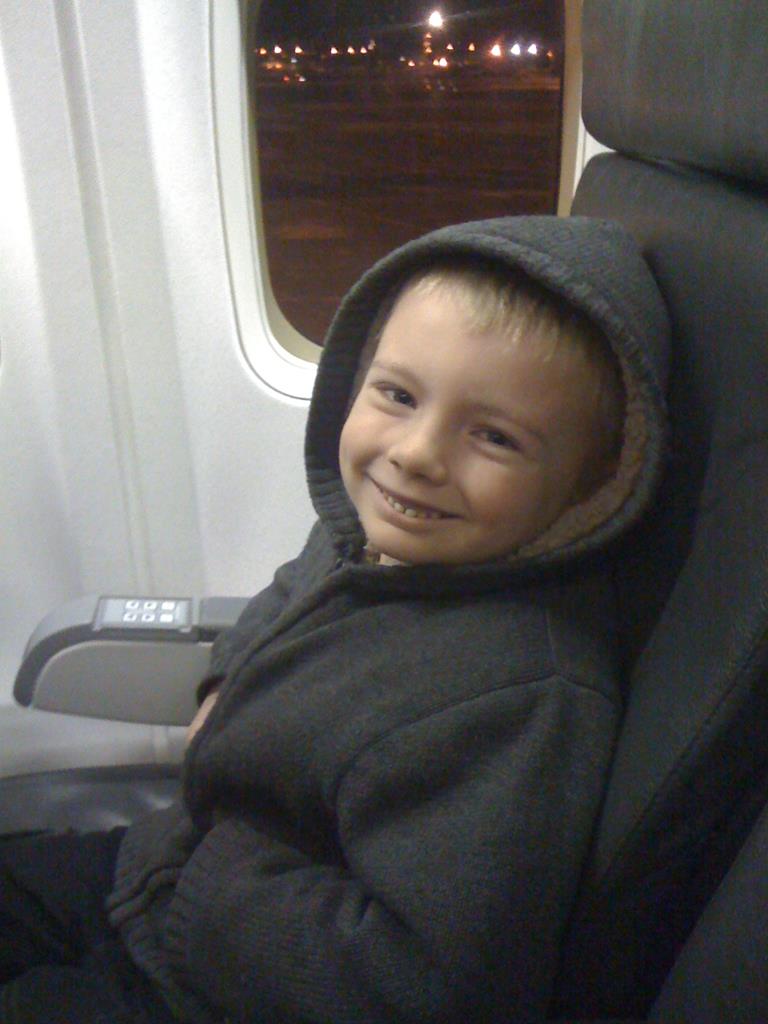 Young boy on an aeroplane seat.