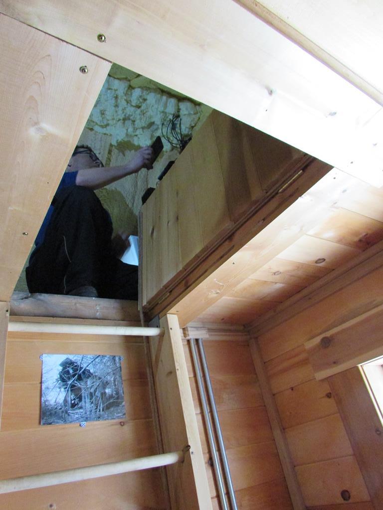 Man viewed through an attic door.